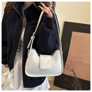 Close-up of white crescent underarm bag featuring a metallic fashion leather finish