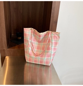 Detail shot of the spacious pink and mint green checkered tote bag made of cotton canvas