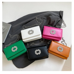 Collection of shiny leather crossbody bags with sparkling crystal buckle and chain straps