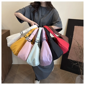 Multi-colored nylon crescent bags with adjustable straps shown in a bouquet layout