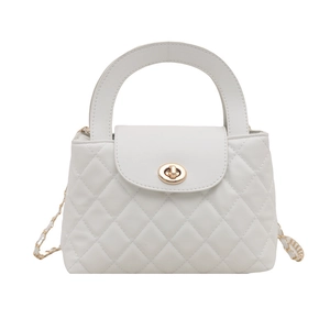 White quilted handbag with gold twist lock and chain strap on white background