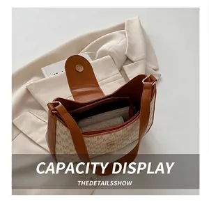 Vue intérieure du sac beige à motif M montrant la capacité pour téléphone et portefeuille