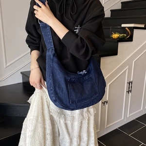 Japanese style dark blue denim hobo bag with a minimalist crescent shape and crossbody strap