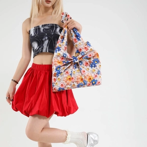 Floral print tote bag with large decorative bow and knotted handle for summer fashion
