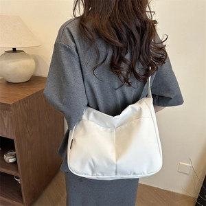 Minimalist white nylon tote bag with puffer design and spacious front pocket for summer
