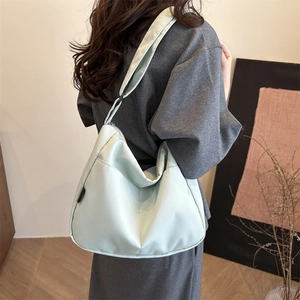 Minimalist mint green large capacity nylon tote bag in a stylish crescent shoulder design
