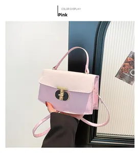 Close-up of pink PU leather bag with logo embossing and unique black-gold turn lock