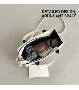 Detail view showing large capacity interior of white crossbody bag with small pouch