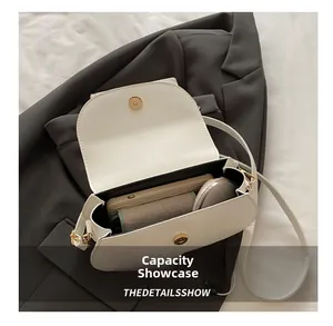 Detailed internal view showing capacity for a phone and makeup in a white saddle bag