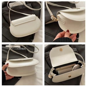Detail view of white saddle bag showing internal capacity for phone and cosmetics