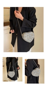 Detail of heart-shaped crossbody bag with blue floral print and silver chain strap
