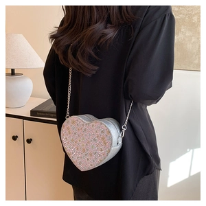 Detail of silver sequined heart crossbody bag with floral stone inlay and chain strap