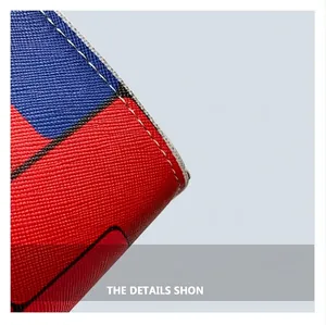 Close-up of red and blue checkered fabric with cross-grain texture and fine white stitching