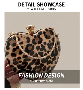Detail of heart-shaped leopard print clutch with gold chain and diamond clasp