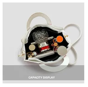 Internal view of the white leather tote bag showing spacious capacity for daily essentials