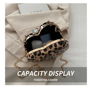 Internal capacity of heart-shaped leopard print clutch with chain and crystal clasp