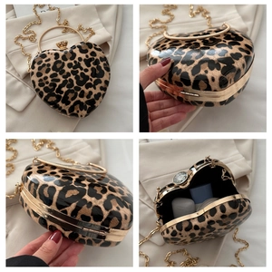 Detail views of heart-shaped leopard print clutch with gold ring handle and chain