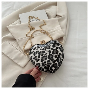 Detailed close-up of heart-shaped leopard print clutch bag with elegant golden handle