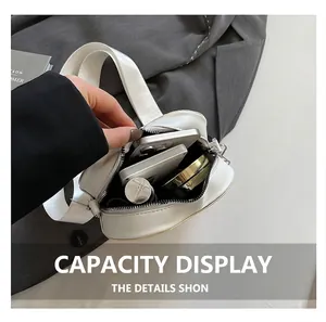 Internal view of a white crossbody bag showing storage for phone, power bank and lipstick
