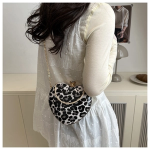 Detailed back view of a heart-shaped leopard print clutch bag with a gold chain strap