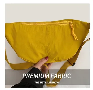 Detail showing bright yellow nylon crescent bag with textured fabric and matching zipper