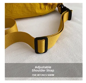 Detail of adjustable wide shoulder strap with black plastic buckle for yellow crossbody bag