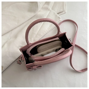 Pink mini crossbody bag interior showing storage space for phone, wallet and accessories