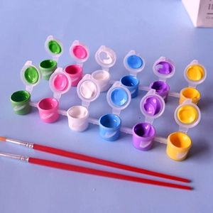 Detailed close-up of 12-color acrylic paint set with two red-handled artist brushes