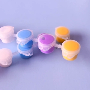 Close-up of vibrant acrylic paint pods in a connected strip for DIY painting crafts