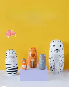 Detailed craftsmanship of 5-piece wooden animal nesting dolls featuring leopard and zebra