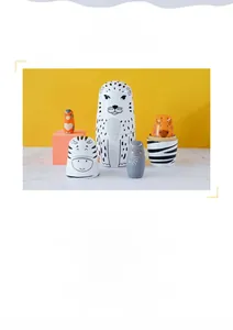 Detailed close-up of hand-painted wooden animal nesting dolls with vibrant wildlife patterns