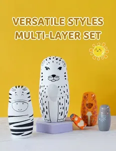 Detail of five-layer leopard and zebra nesting dolls on a purple geometric pedestal