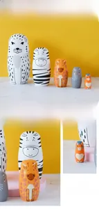 Detail of 5-piece set of hand-painted wooden nesting dolls with colorful animal motifs