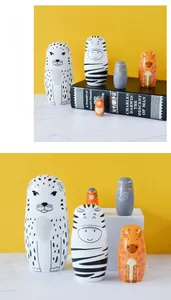 Detailed set of 5 hand-painted wooden animal nesting dolls on marble surface