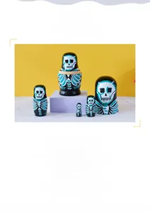 Detailed view of hand-painted five-piece wooden nesting dolls with skull theme design