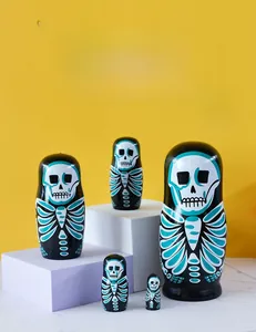 Detailed set of 5 hand-painted skull-themed wooden nesting dolls on a vibrant yellow backdrop