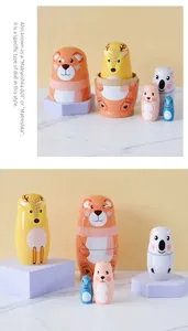 Detailed view of 5-piece cartoon bear and deer animal nesting dolls set on marble surface