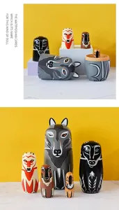 Detail of five handcrafted wooden nesting dolls with forest animal paintings