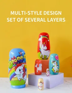 Detail of handcrafted wooden Russian nesting dolls featuring colorful unicorn and owl patterns