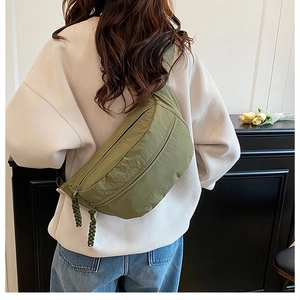 Close-up of military green large capacity tote bag featuring woven texture zipper pulls