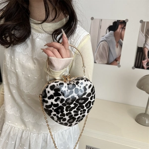 Fashionable leopard print heart-shaped crossbody bag with gold metal frame and crystal clasp