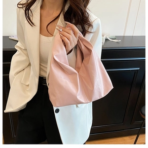 Détail montrant la texture en cuir synthétique rose tendre et le design minimaliste du sac