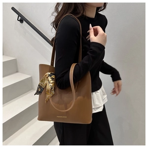 Brown leather tote bag featuring a decorative printed scarf and Fashion & Bags text detail