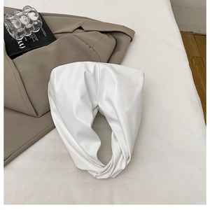 Close-up of minimalist white hobo bag with soft leather texture and elegant folds