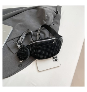 Detail of black rhinestone waist bag with wide woven strap and small round pouch
