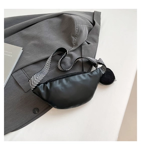 Detail of black crescent crossbody bag with zigzag wide strap and small round pouch