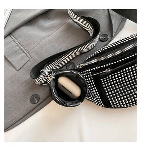 Detail of black rhinestone crossbody bag with woven strap and a small coin pouch