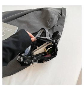 Top view of rhinestone waist bag interior storage showing phone and cosmetics space