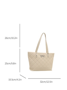 Cream quilted tote bag with silver bow detail and dimensions shown on white background