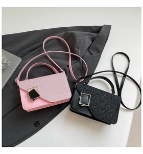 Detail of pink and black mini crossbody bags with glitter texture and metal buckle